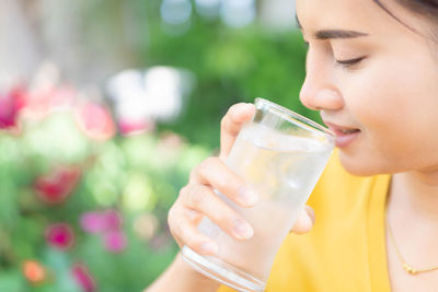 Close-up of woman drinking glass
