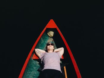 Portrait of a girl sitting on wooden floor at night