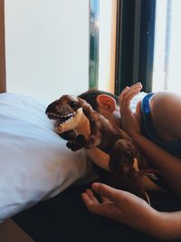 Midsection of woman with dog at home