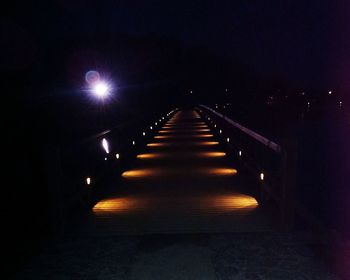 Illuminated tunnel at night