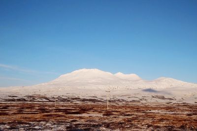 Scenic view of snow covered mountains against sky