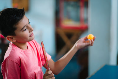 Portrait of child playing table tennis