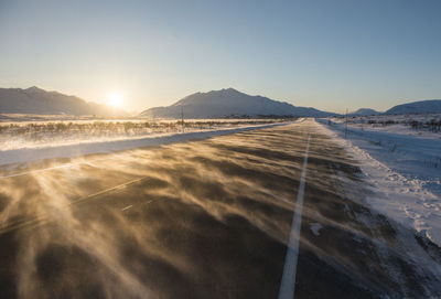 Road against mountains and clear sky during sunrise