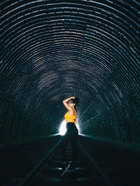 Woman standing in tunnel