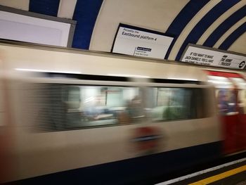 Blurred motion of train at railroad station