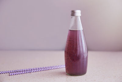 Non-alcoholic detox vegan healthy organic bottle of drink with blueberries and chia seeds. 
