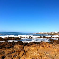 Scenic view of sea against clear blue sky