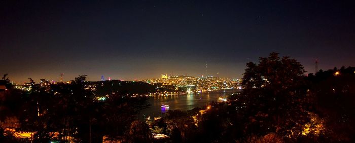 High angle view of illuminated buildings against sky at night