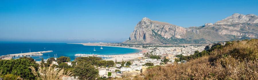 Panoramic shot of bay against clear blue sky