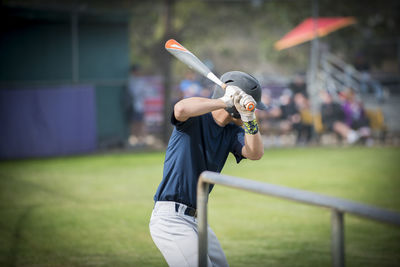 Teen baseball player ready to hit in the on deck circle