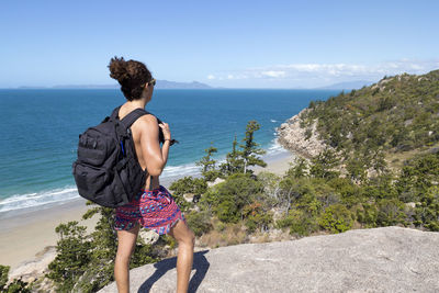 Rear view of woman looking at sea against sky