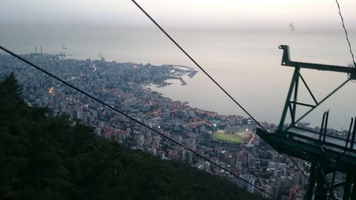 Overhead cable car over river in city