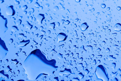 Full frame shot of wet blue glass