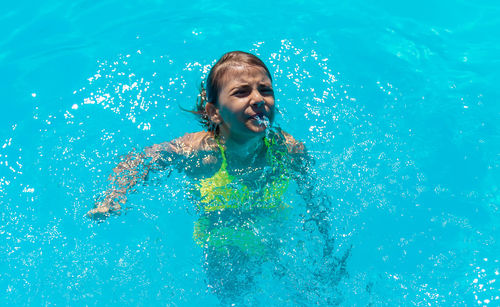 Young woman swimming in pool