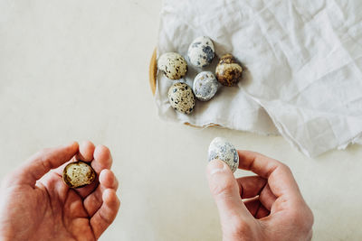 People hands put collected quail eggs in plate. cooking vegan egg dishes.selective focus