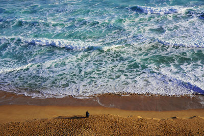 High angle view of waves on beach