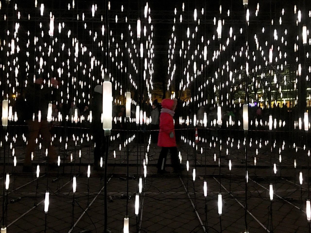 REAR VIEW OF WOMAN STANDING ON WALKWAY