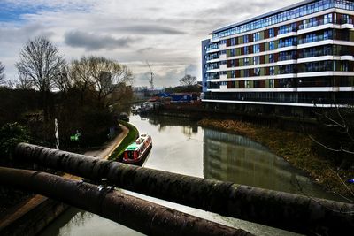 Boats in river with buildings in background