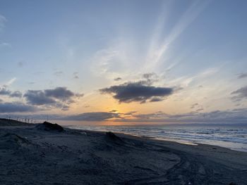 Scenic view of beach against sky during sunset