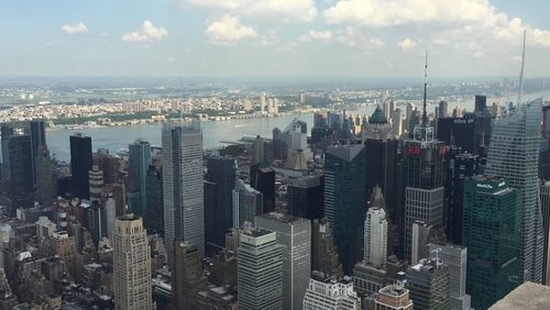 High angle view of cityscape against cloudy sky