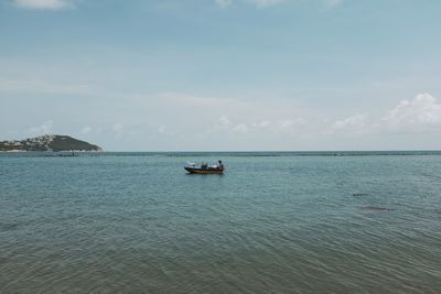 Boats sailing in sea against sky