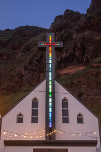 Low angle view of information sign on mountain against sky