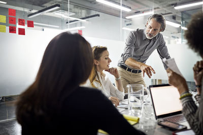 Colleagues having meeting in conference room at office