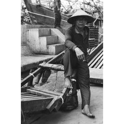 Rear view of man standing on railing