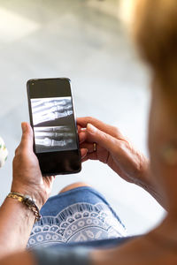 Midsection of woman using mobile phone