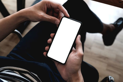 Midsection of man using mobile phone
