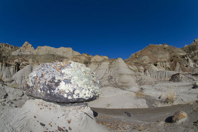 Panoramic view of rocks against clear blue sky