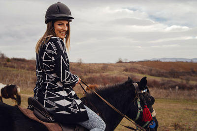 Man riding horse on field