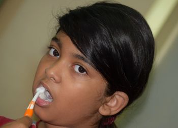 Close-up of girl brushing teeth