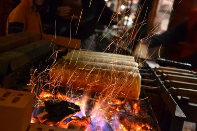 Close-up of lit candles on barbecue