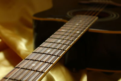 Close-up of guitar on fabric