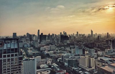 High angle view of modern buildings against sky during sunset