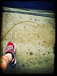 Low section of person standing on tiled floor