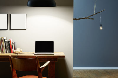 Illuminated electric lamp on table at home