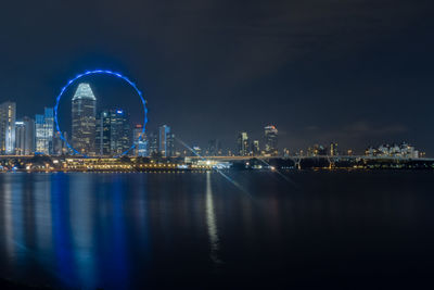 Illuminated city buildings at waterfront