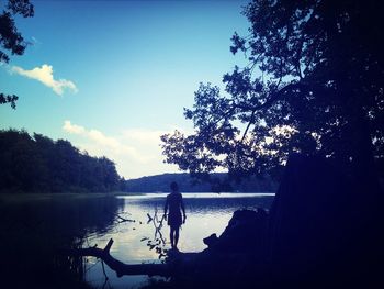 Calm lake with trees in background
