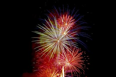 Low angle view of firework display at night