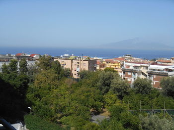 High angle view of buildings by sea