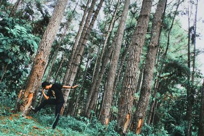 Man posing against trees in forest