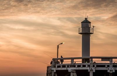 Low angle view of lighthouse against cloudy sky