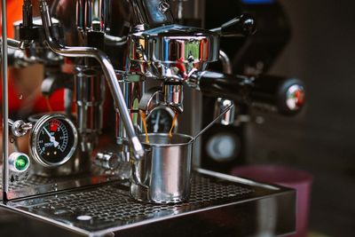 Coffee pouring in cup from machinery