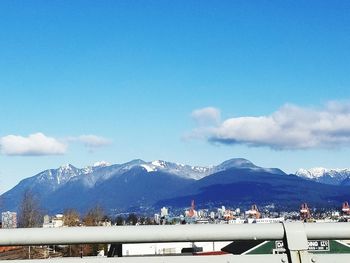 Scenic view of snowcapped mountains against blue sky