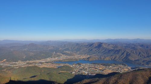 Aerial view of mountain range against blue sky