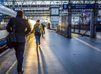 Woman walking on railroad track