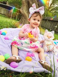 Portrait of cute girl sitting outdoors