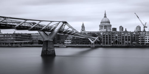 View of bridge over river against buildings